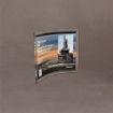 Angled view of small Curved Process Lucite® Plaque featuring offshore oil rig image and full-color print for ADNOC and Weatherford recognition