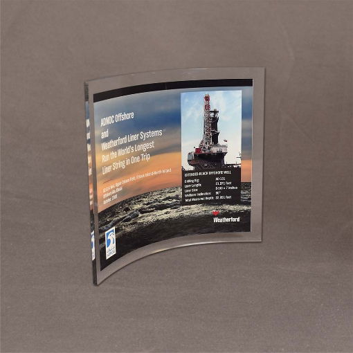 Medium-sized Lucite® Curved Process Plaque shown at an angle, highlighting vibrant offshore drilling imagery and layered acrylic depth