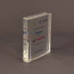 Side profile of large slim Lucite® embedment shaped like a book spine, highlighting its minimal depth and polished edge finish