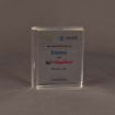 Front-facing view of small slim Lucite® embedment styled like a book, highlighting a corporate acquisition event in clean, modern design