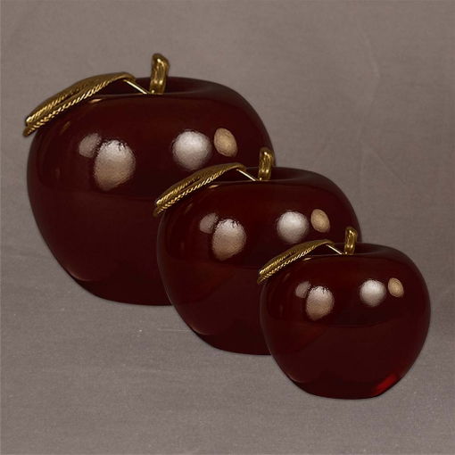 Group of three solid red Lucite® apples with gold leaf, in small, medium, and large sizes for versatile display or gifting.