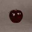 Small red apple award with gold stem and leaf, presented from the front to show its classic rounded shape and rich red color.