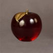 Large apple recognition piece in rich translucent red, shown from the side to highlight its polished curves and golden stem detail.