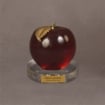 Small red apple award on a clear Lucite® base with engraved plate, ideal for celebrating educators or team achievements.