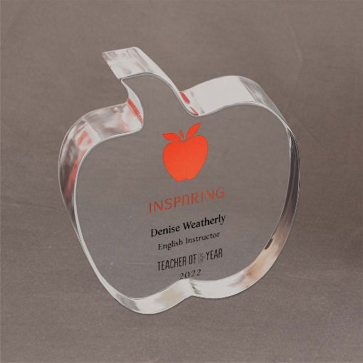 Clear Lucite® apple-shaped trophy with red graphic and custom printing honoring Denise Weatherly as Teacher of the Year in 2022.